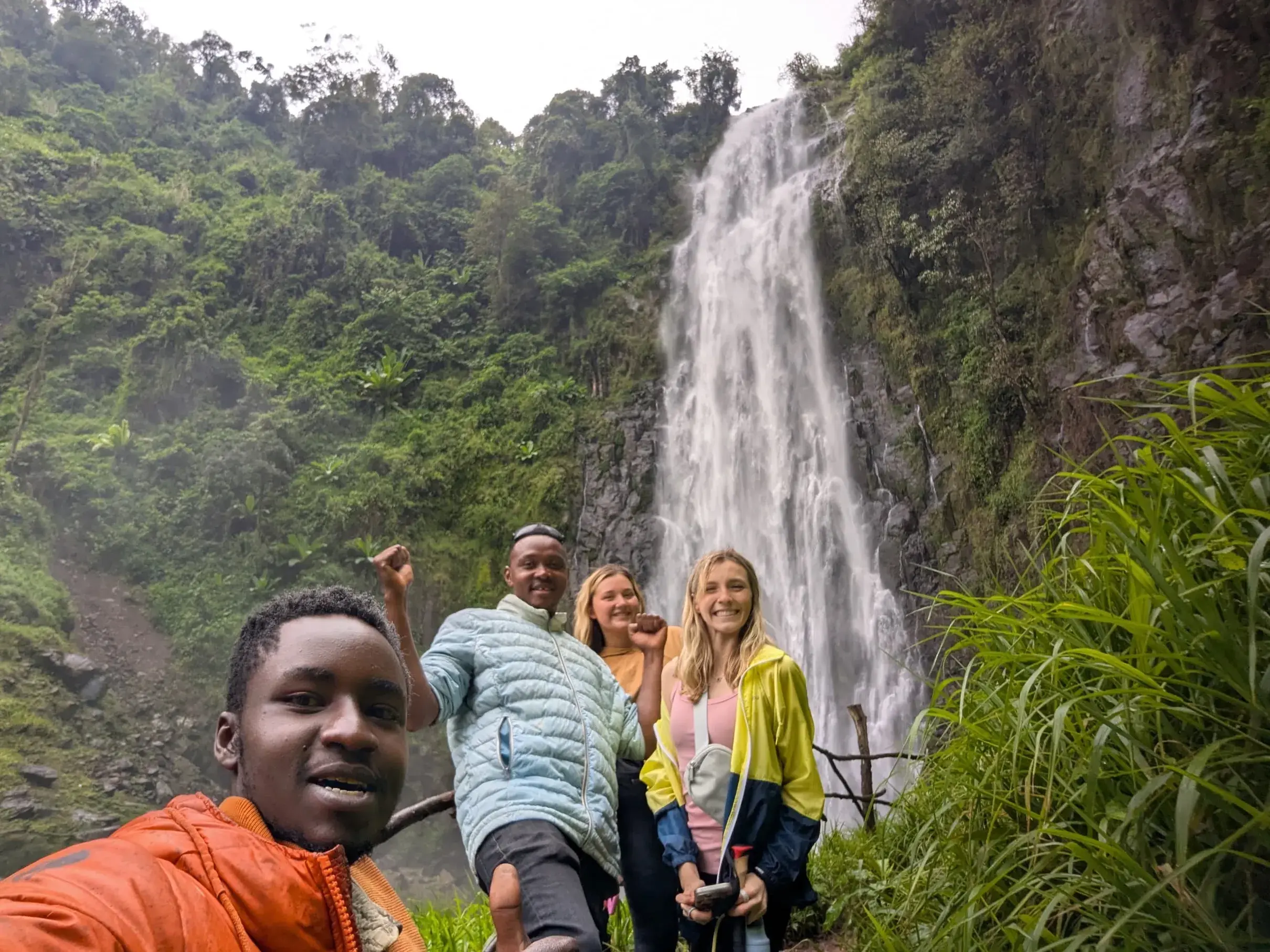 Nateleigh Nachreiner in front of waterfall in Tanzania with three others