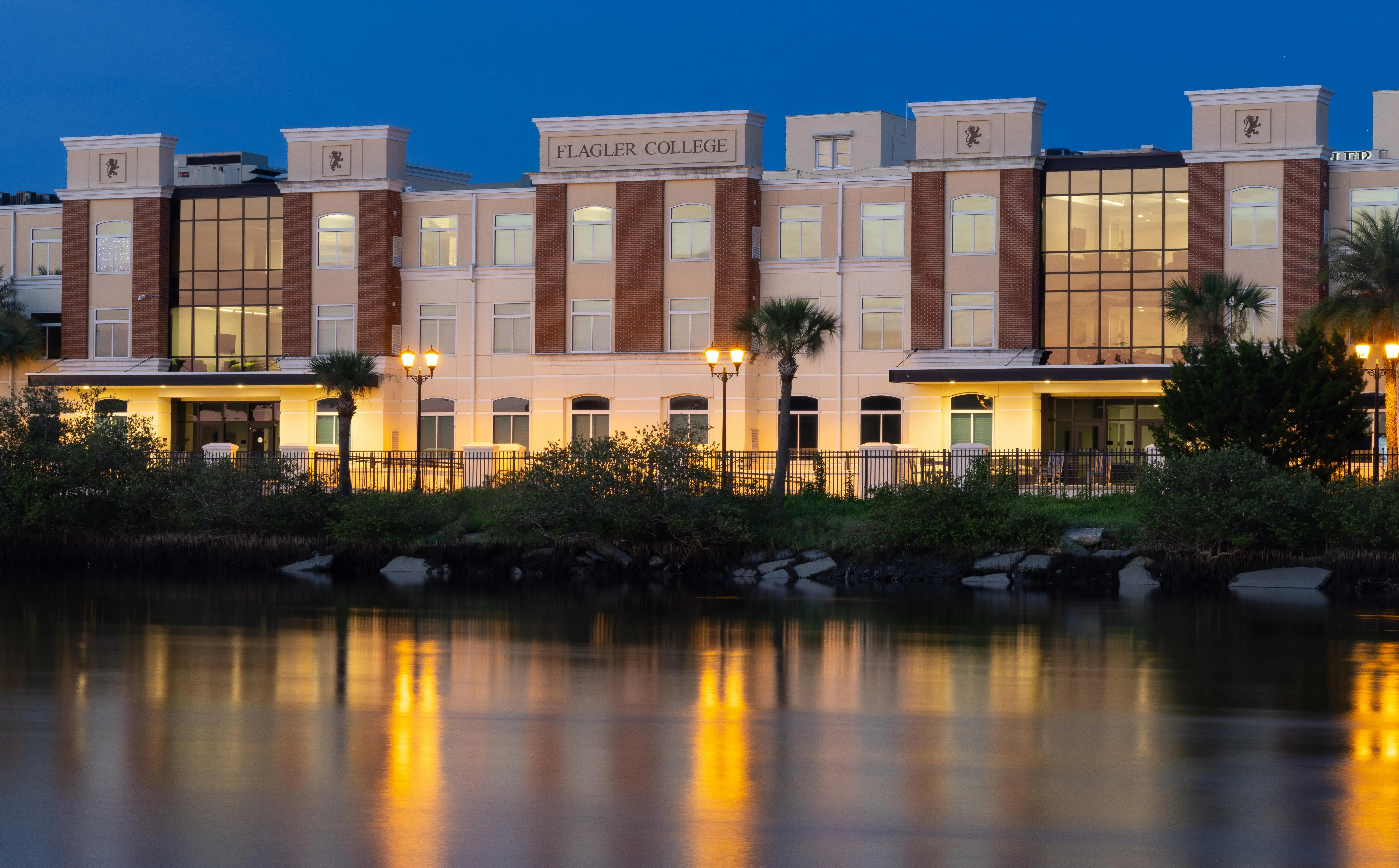 Abare Hall exterior at night with the waterfront in the foreground
