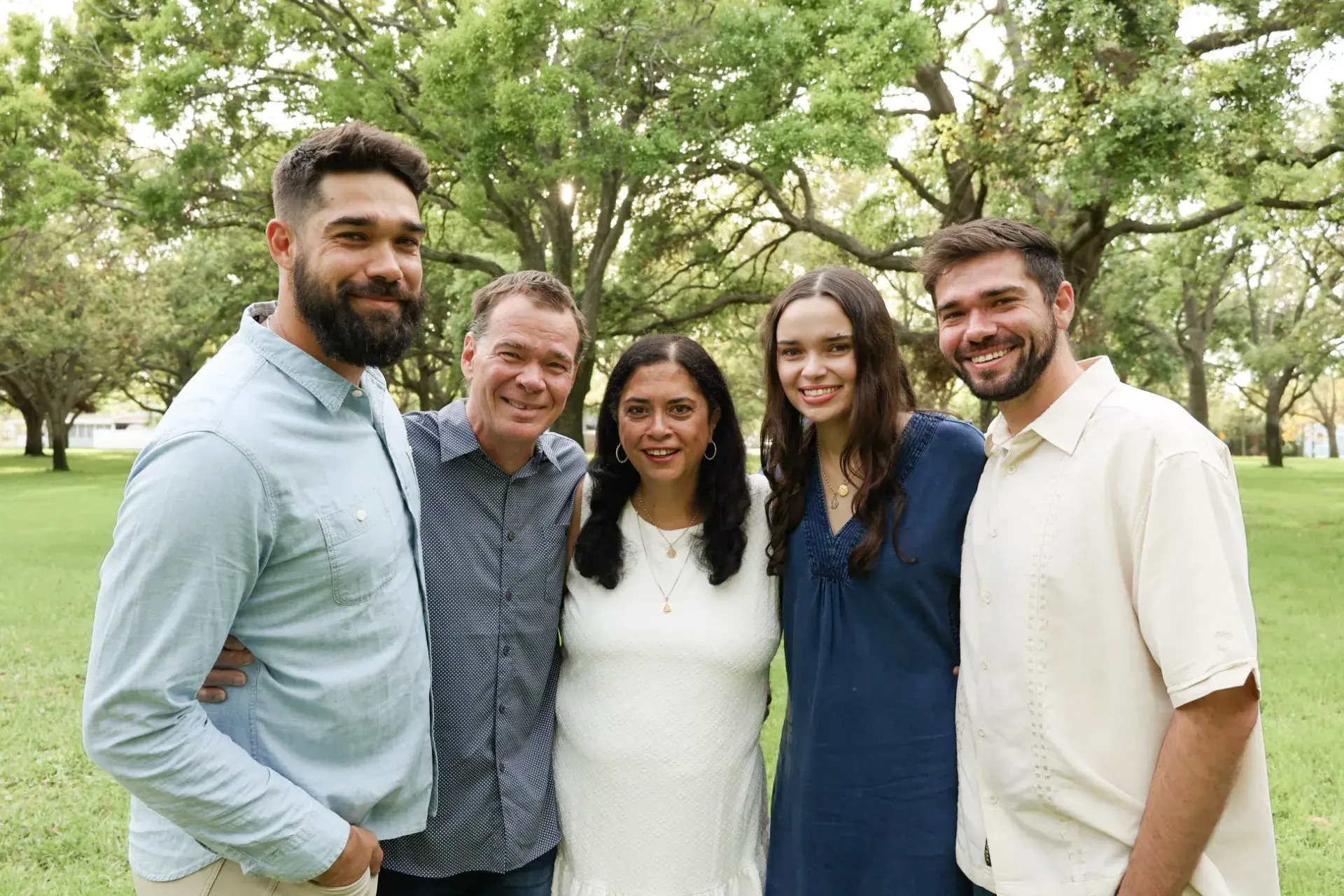 Lulu and Dave Benedict pose with family in a wooded area
