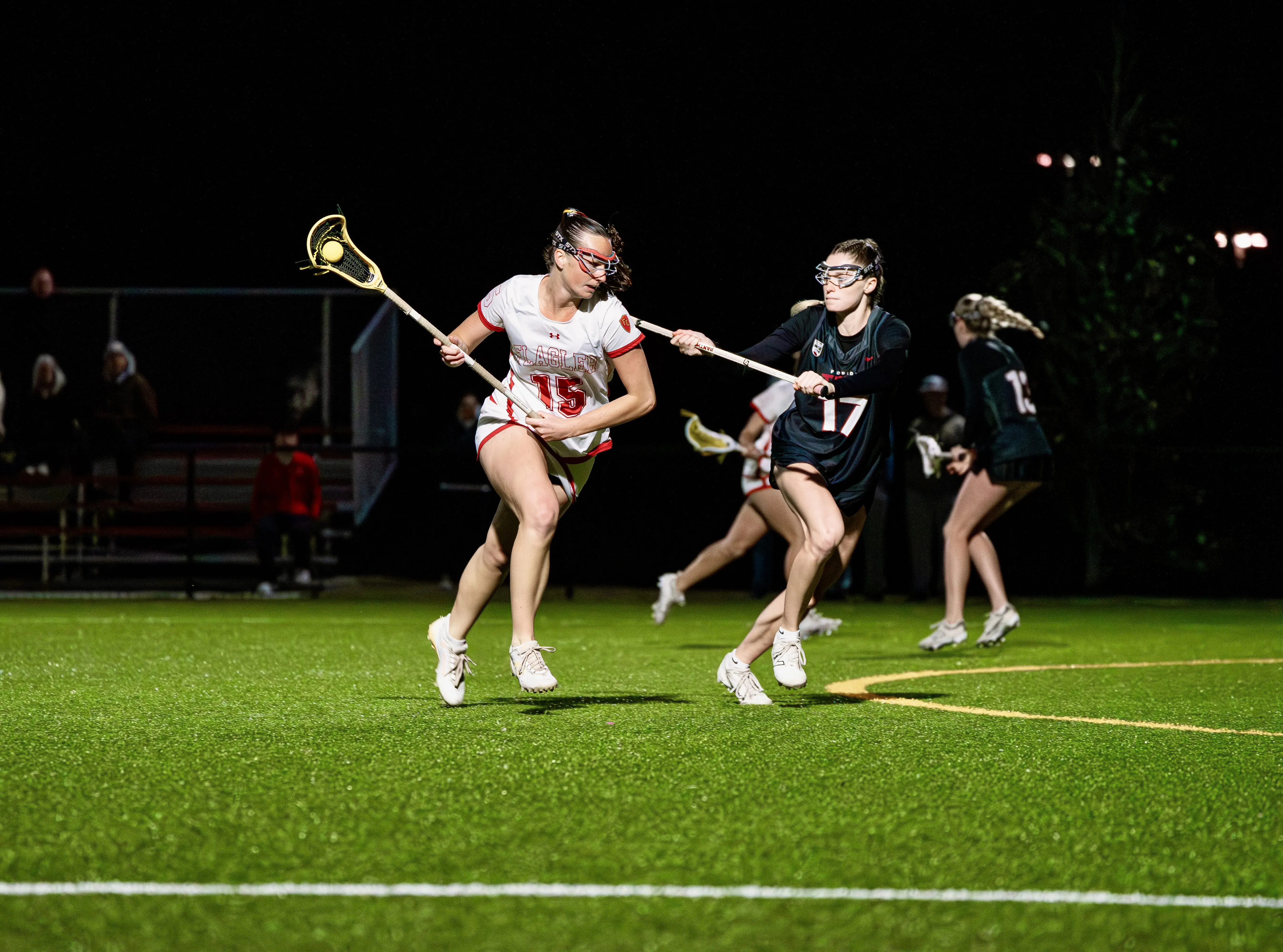 Ella Pinder dodging a defender while she heads to the goal during a Flagler women's lacrosse game