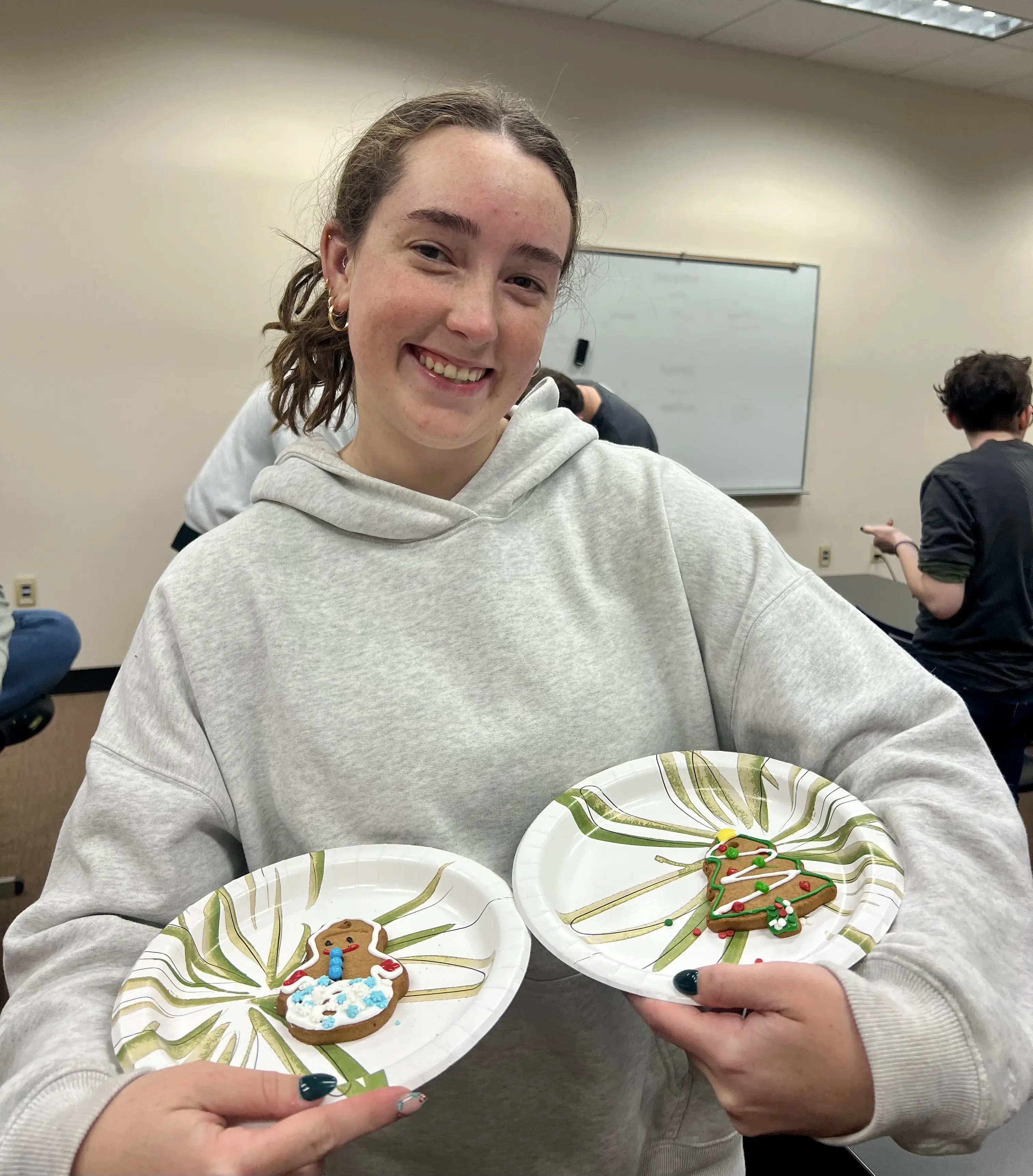Maddie Nilan holding cookies at a deaf awareness club meeting