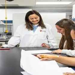 Photo of professor helping students in the lab