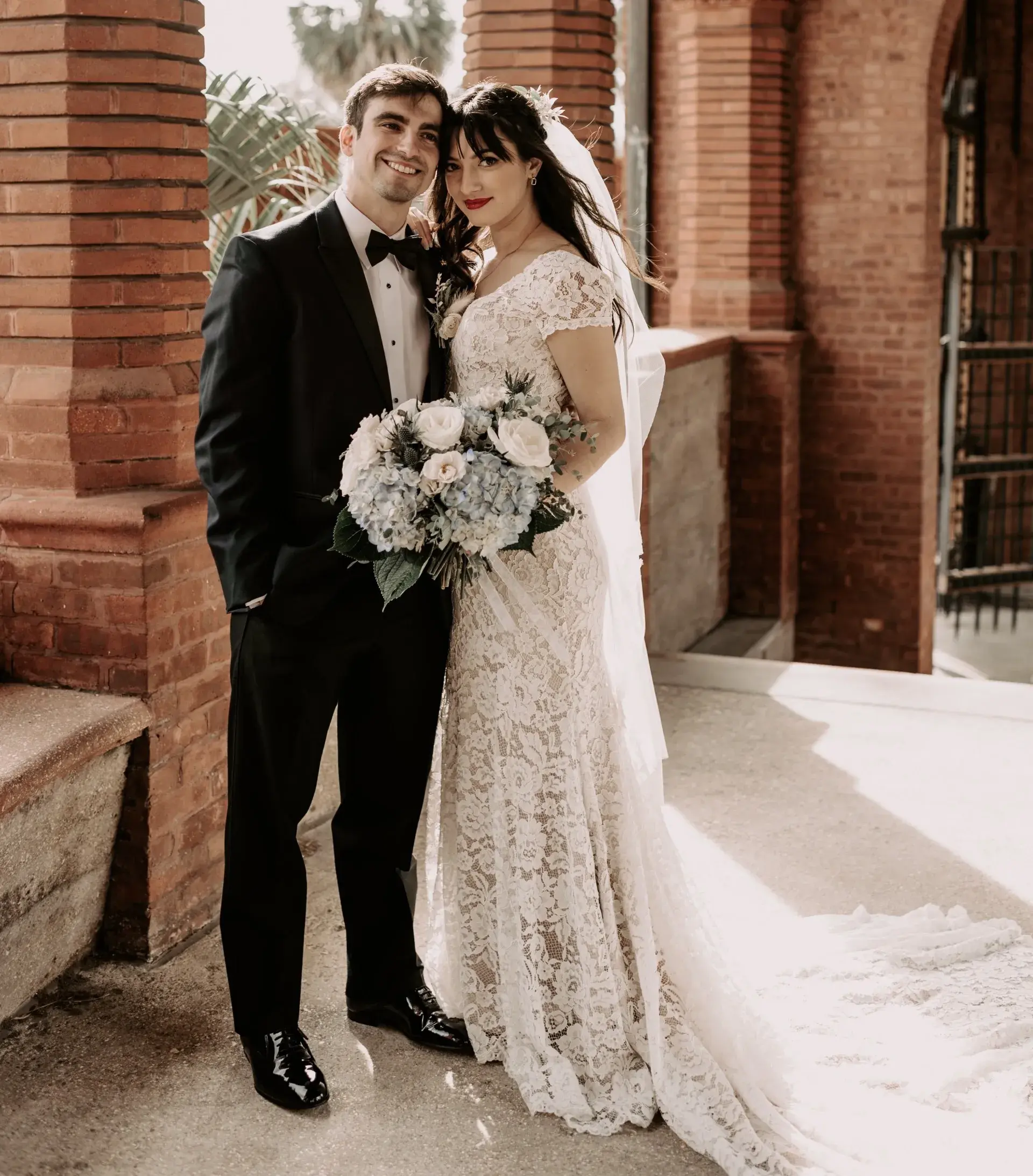 Kiara and Daniel Sanchez stand in their wedding attire outside of The Ponce