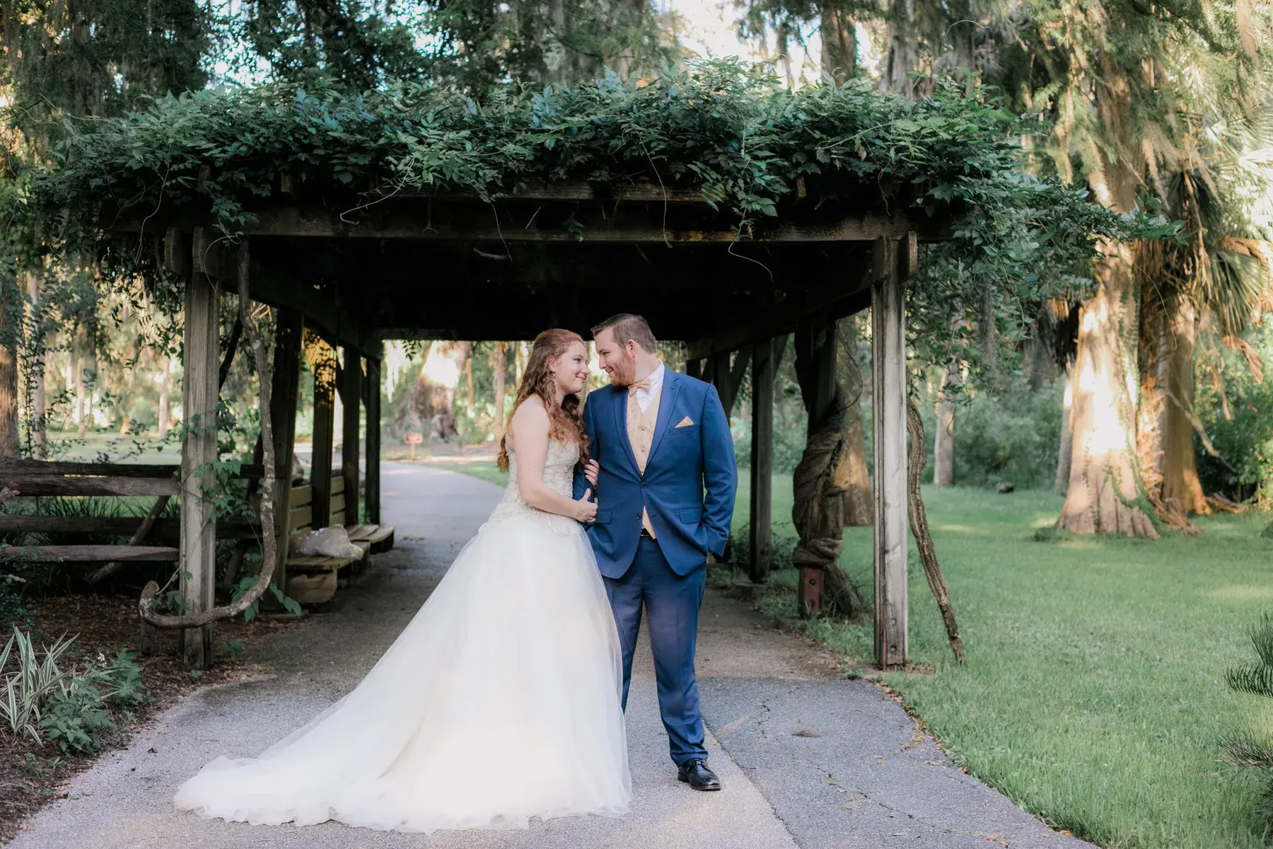 Carie and Zach Moore pose for a wedding photo in their wedding attire