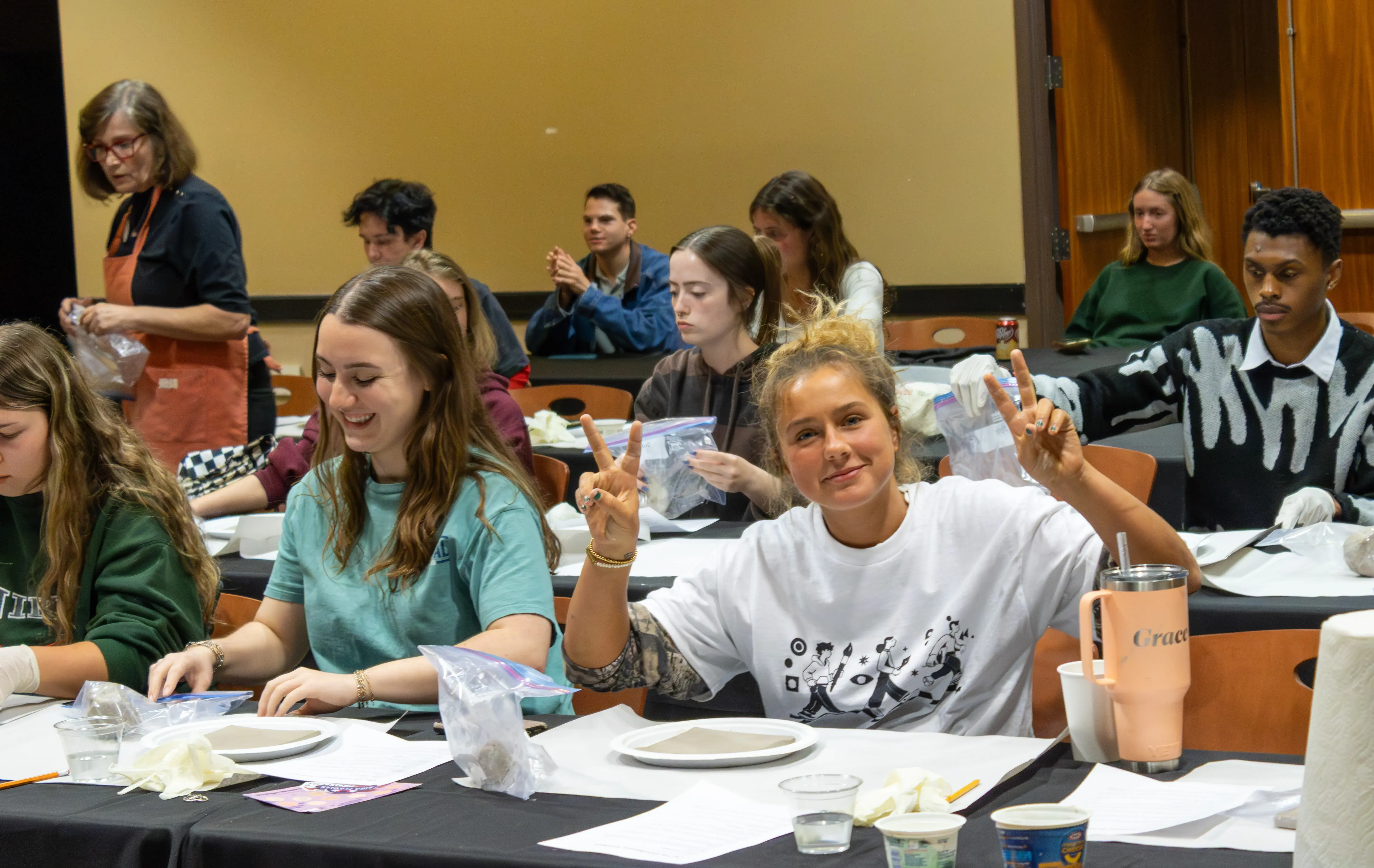 Students having fun and posing for a picture at the tile making seminar