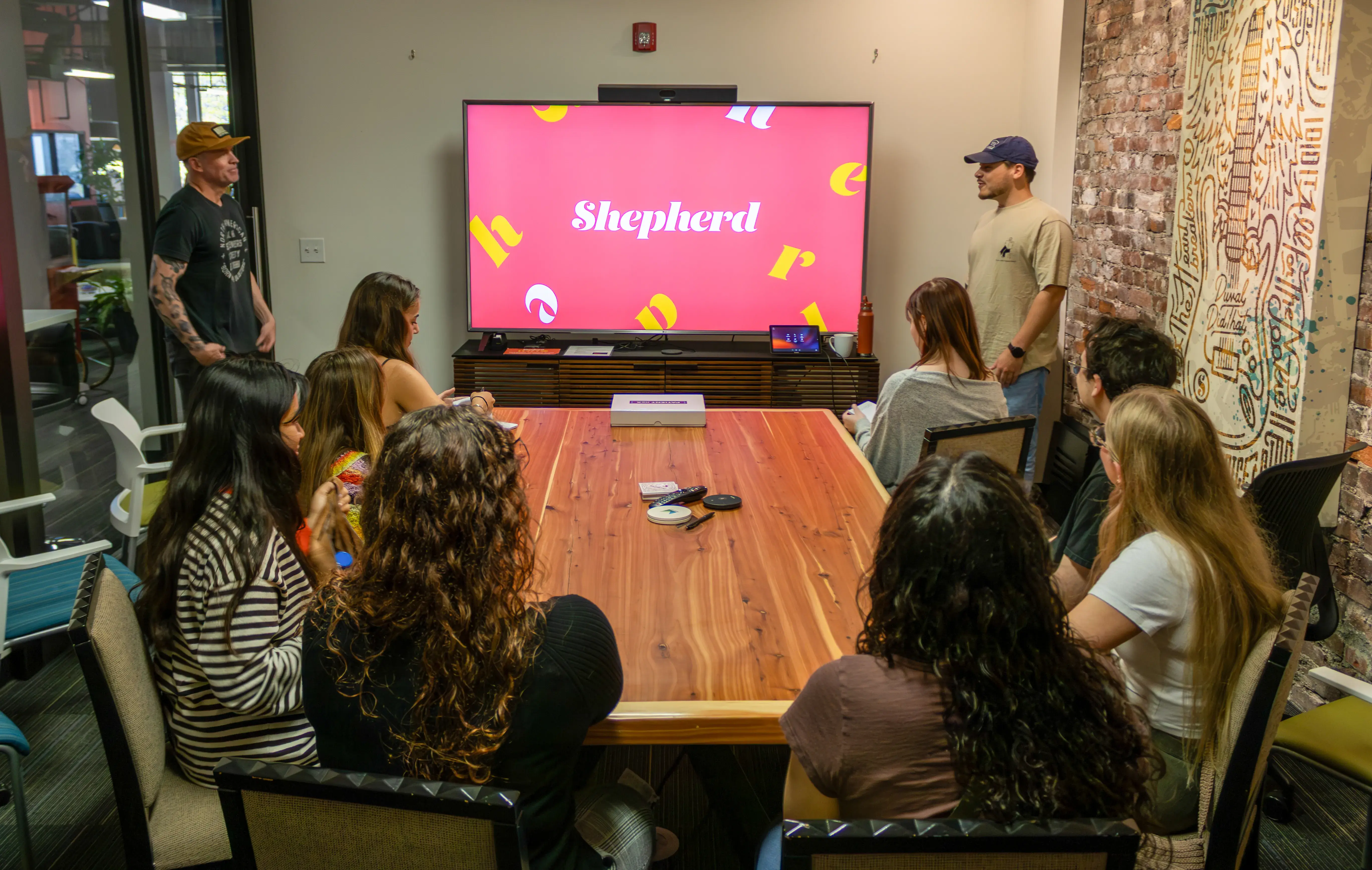 Flagler students sit around a conference table waiting for a presentation at Shepherd Advertising Agency