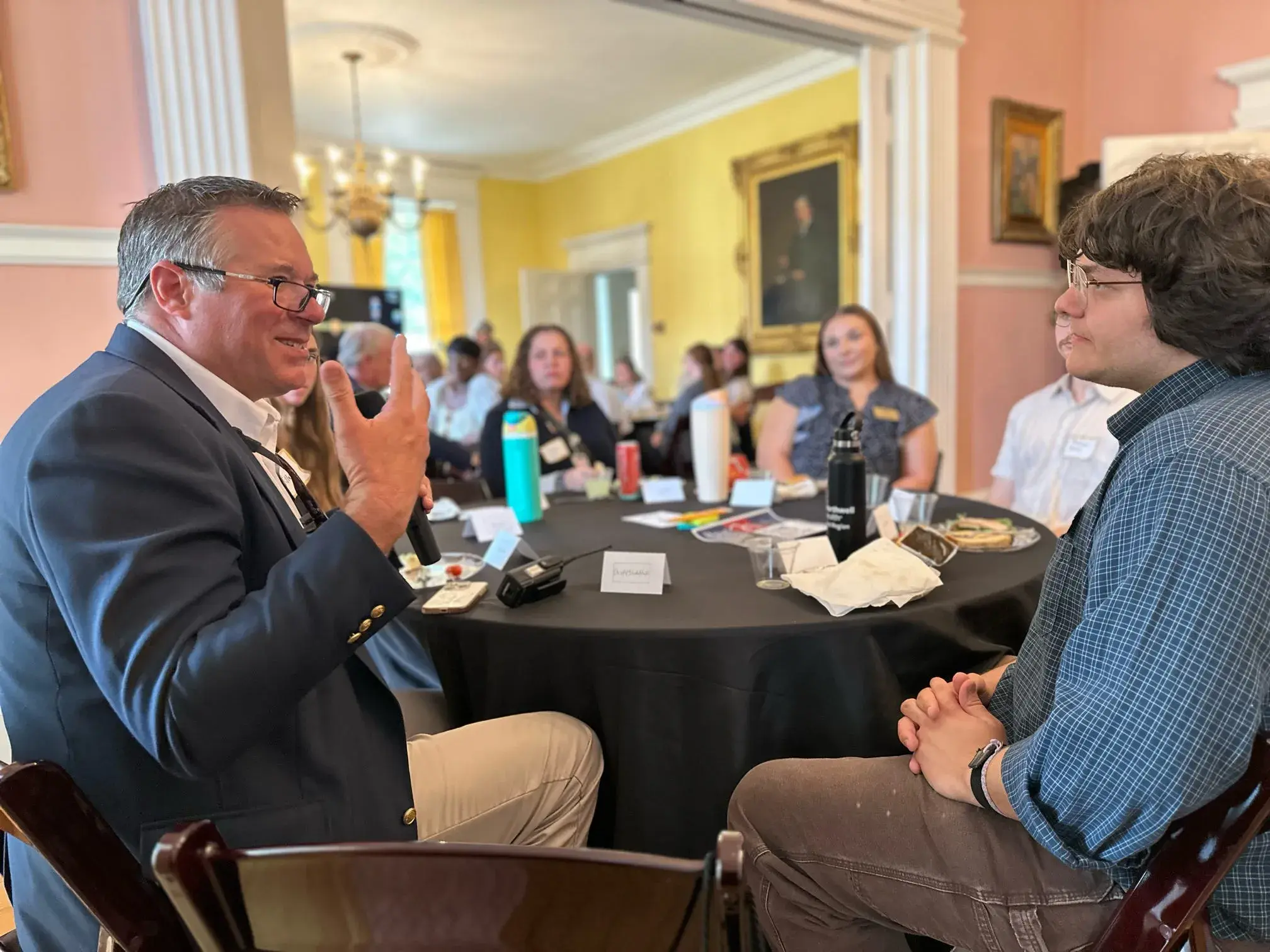 A student and teacher have a discussion at the kick off luncheon