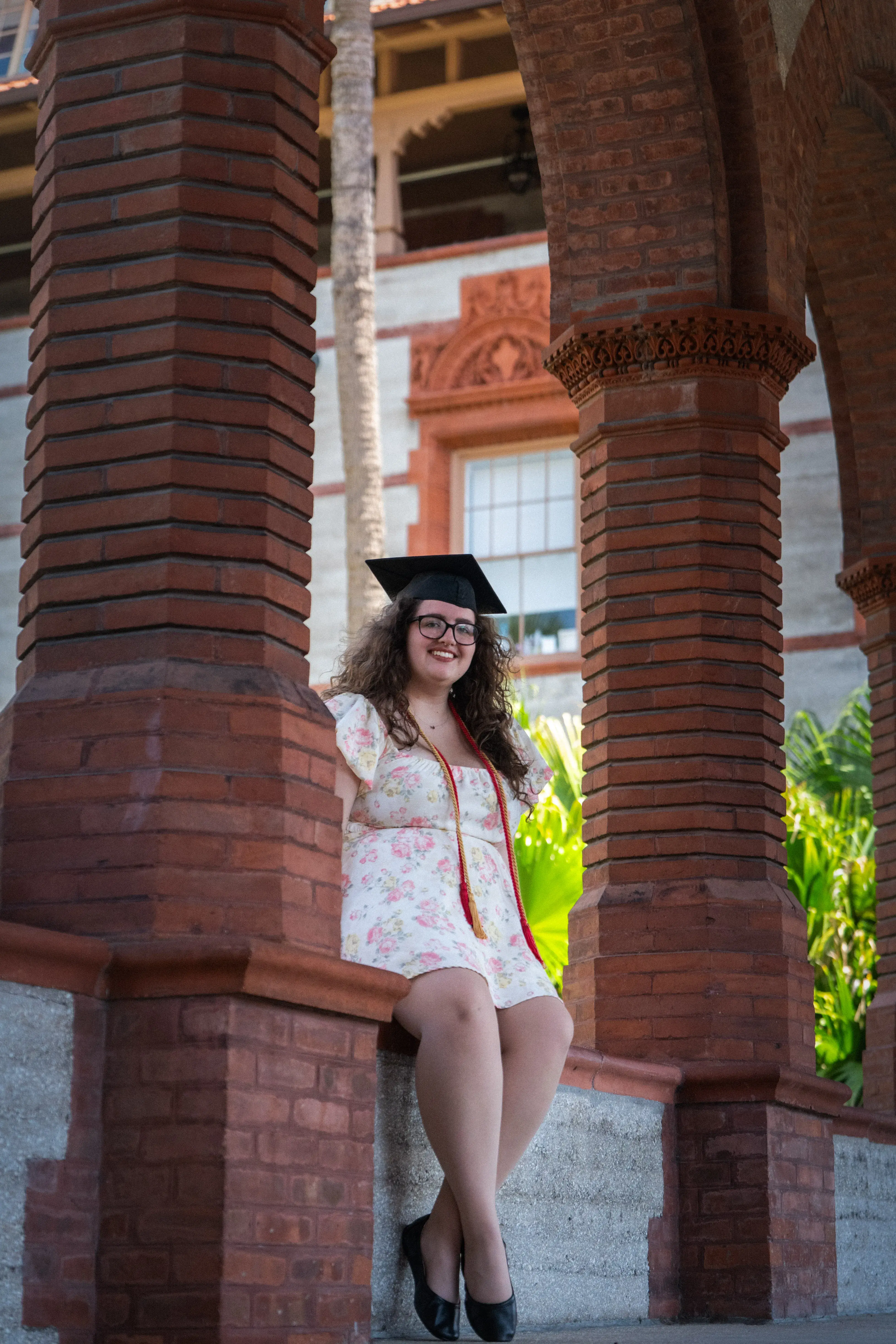 Abby Surber sitting on a ledge outside of The Ponce