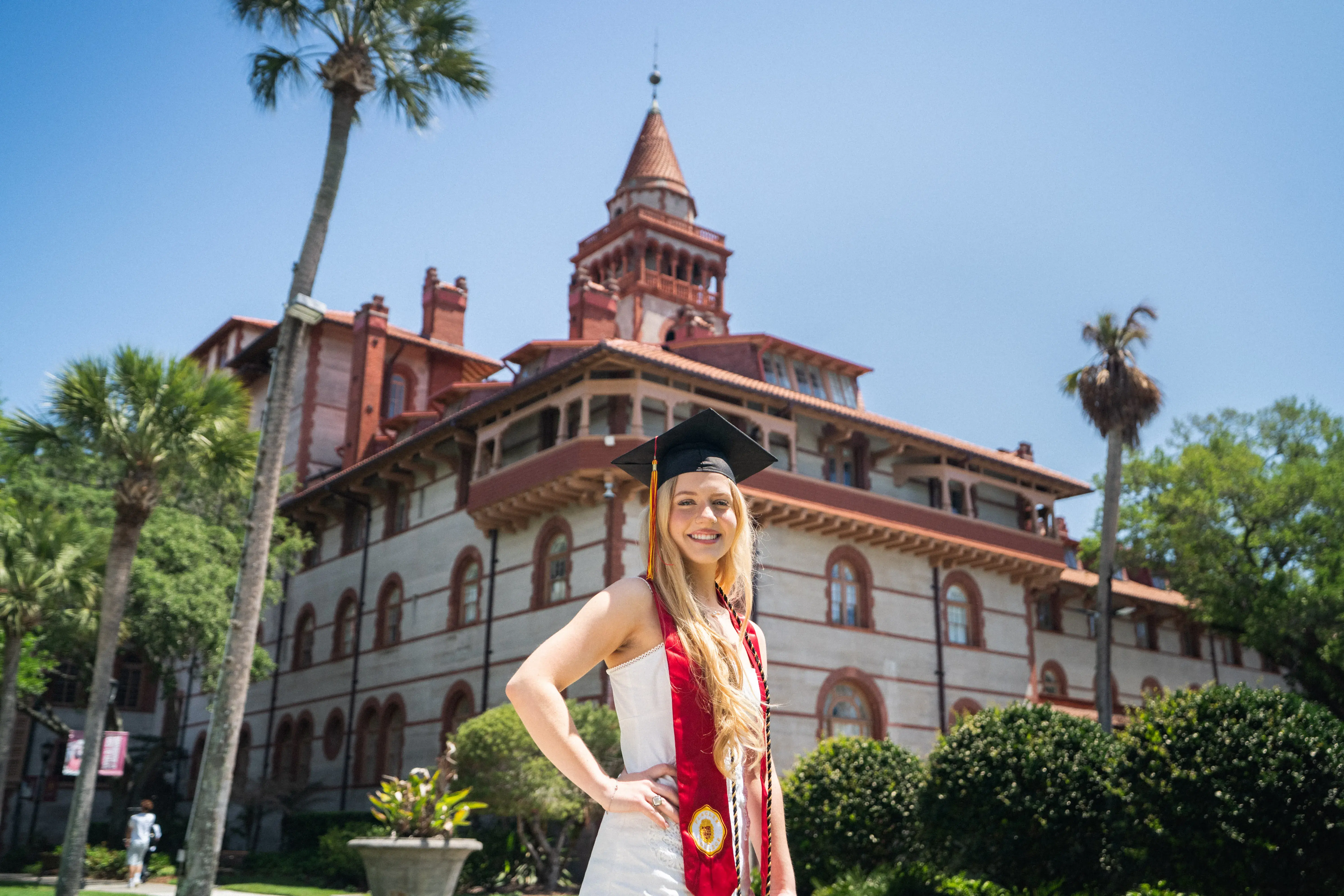 Ava Mantha poses in her grad cap with a Ponce tower in the background