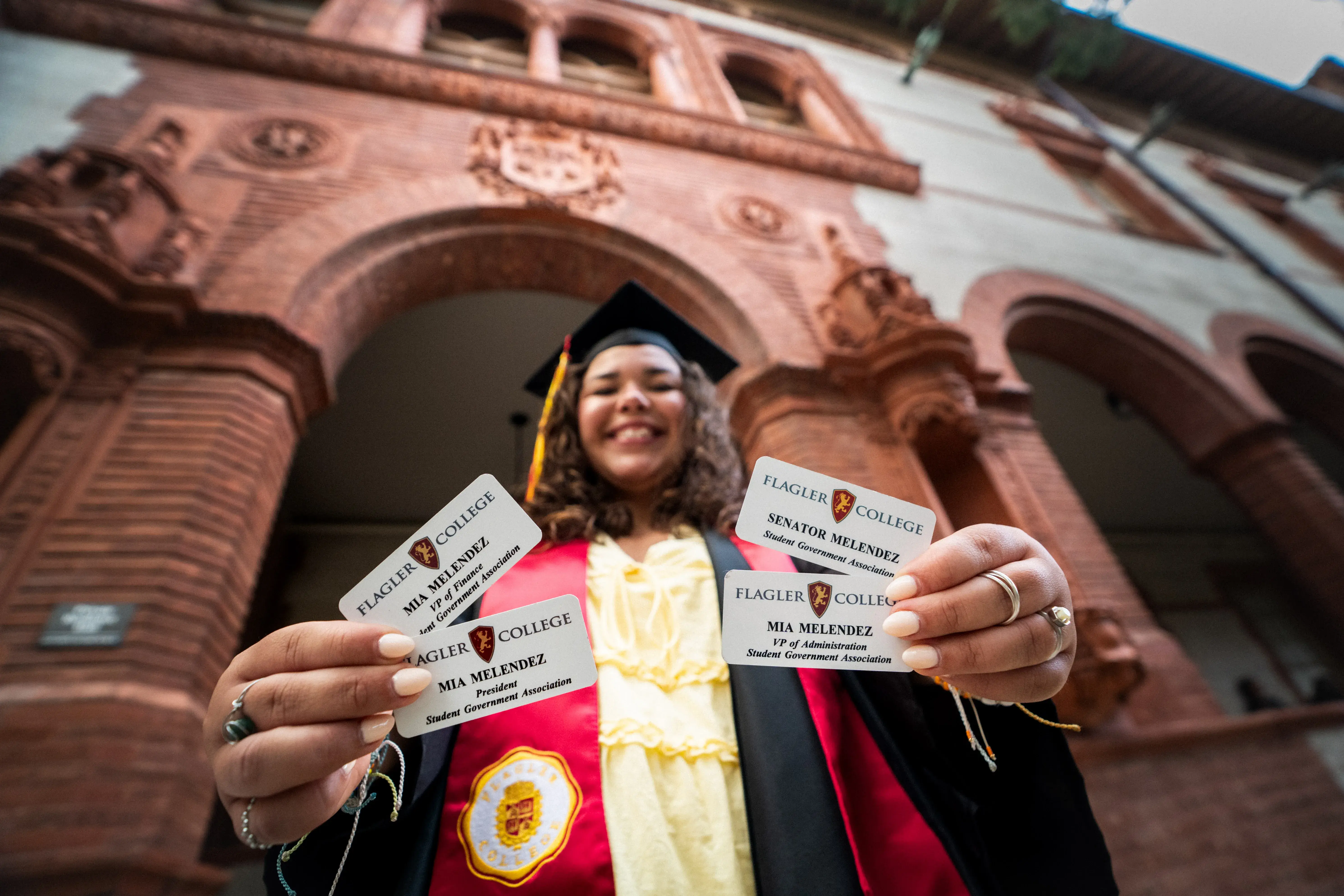 Mia Melendez holding all of her SGA nametags from her various positions