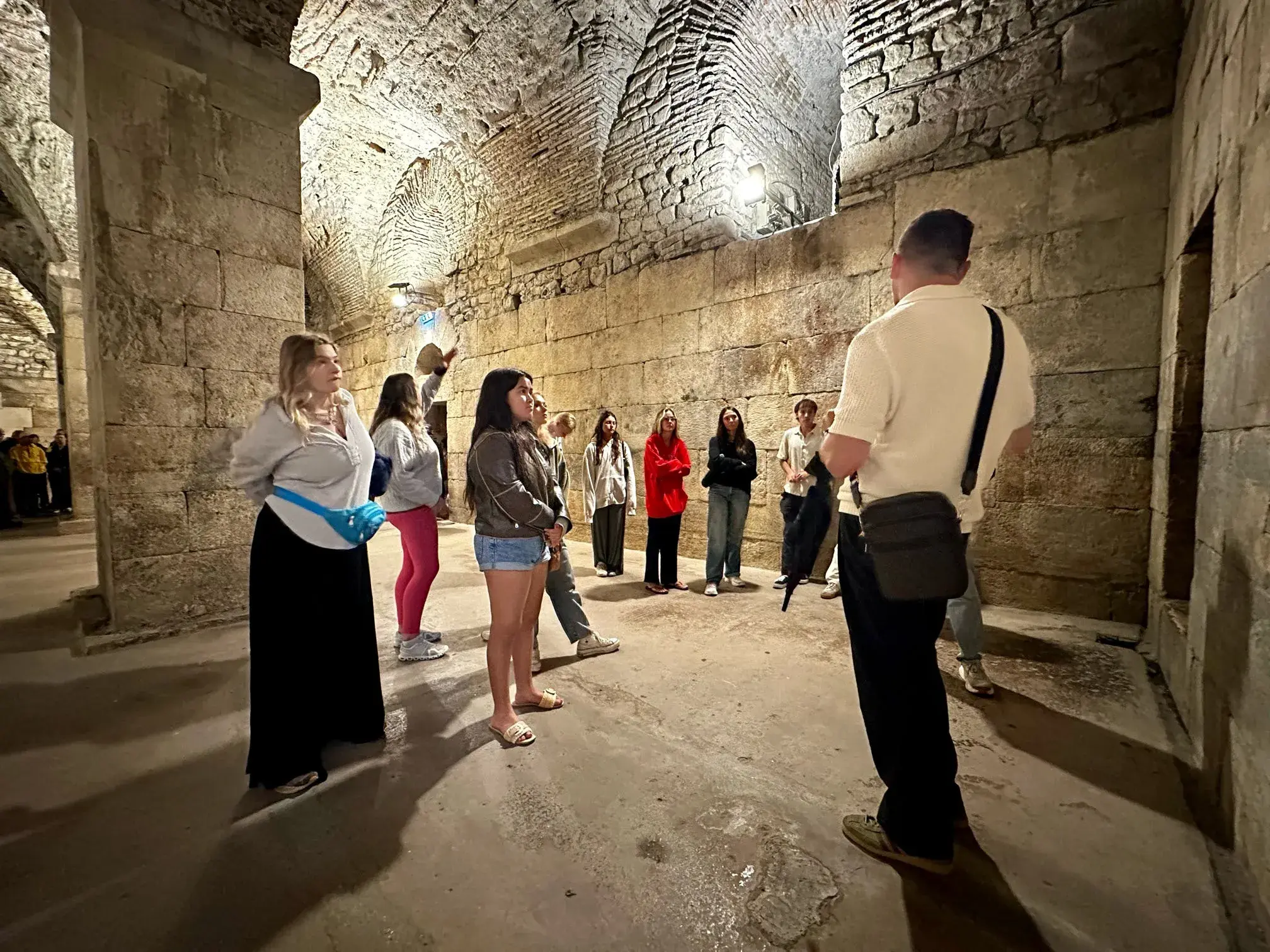 Students listening to their tour guide while in the palace