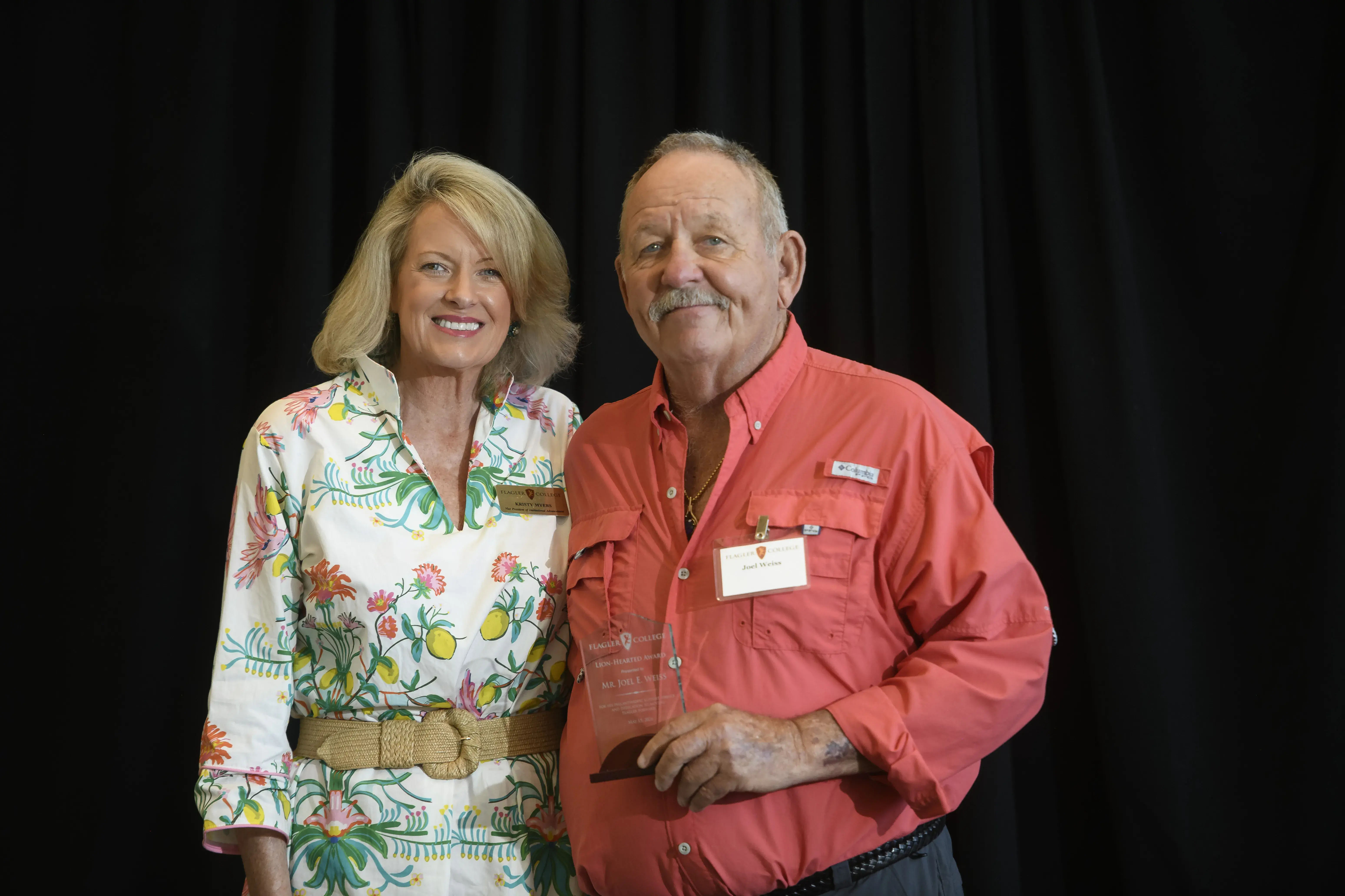 Joel Weiss and Kristy Myers pose for a staged photo with Joel's award