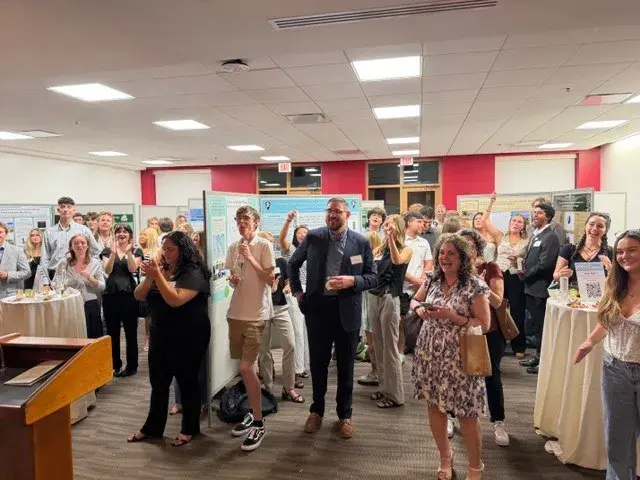 A wide shot of the room during the senior symposium presentation event