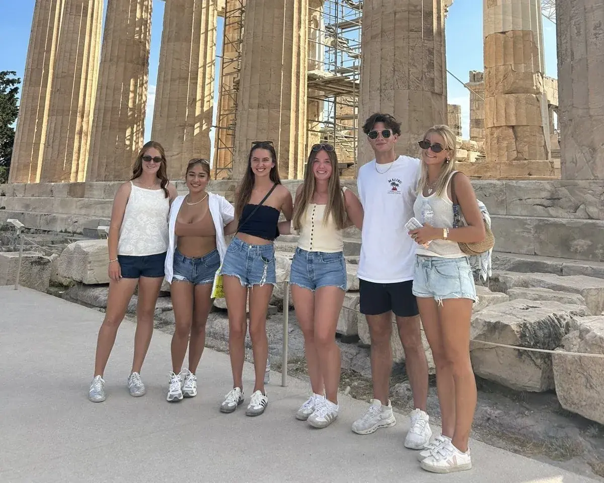 The student group posing in front of an Anicent Greek ruin