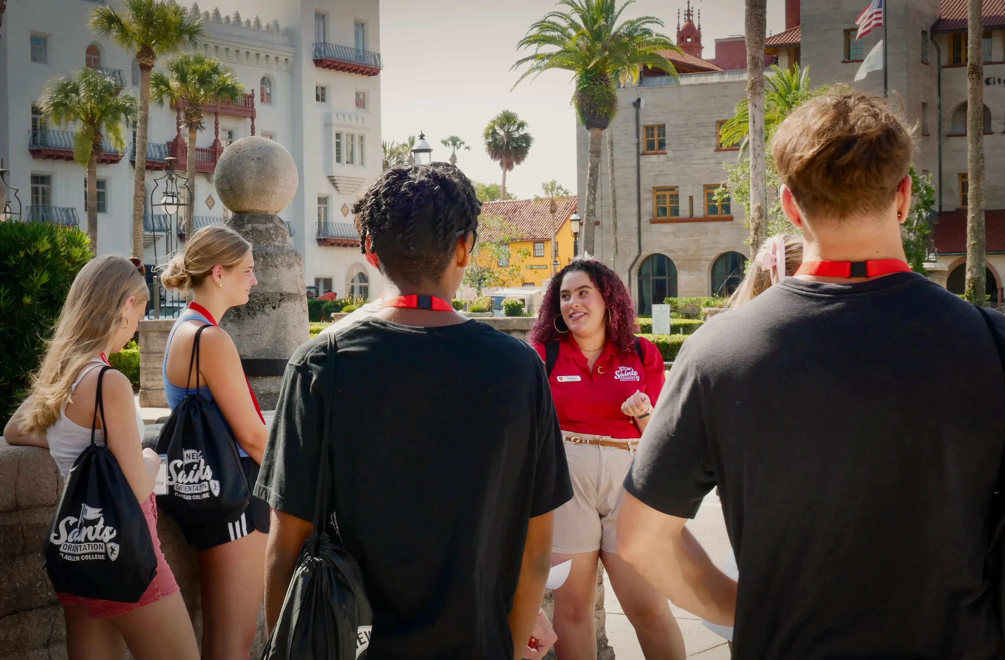 An orientation leader presents to a group out front of the Lightner Museum