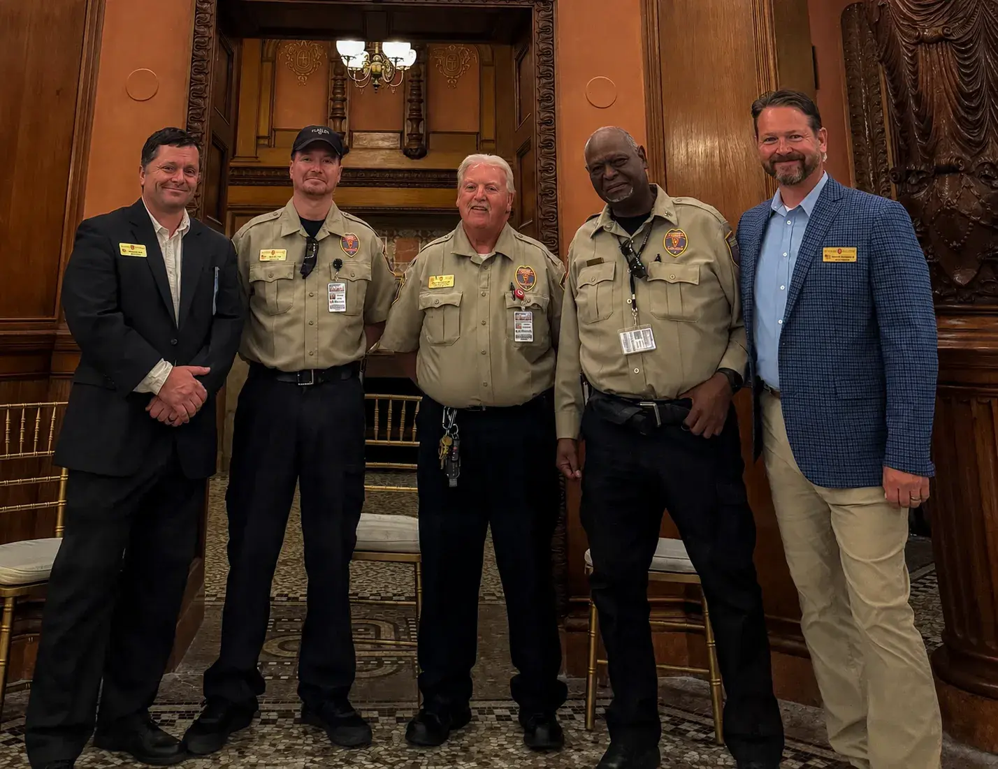William Bird (left) and Trent Theobald (right) flank a group of Flagler security officers while they pose for a photo.