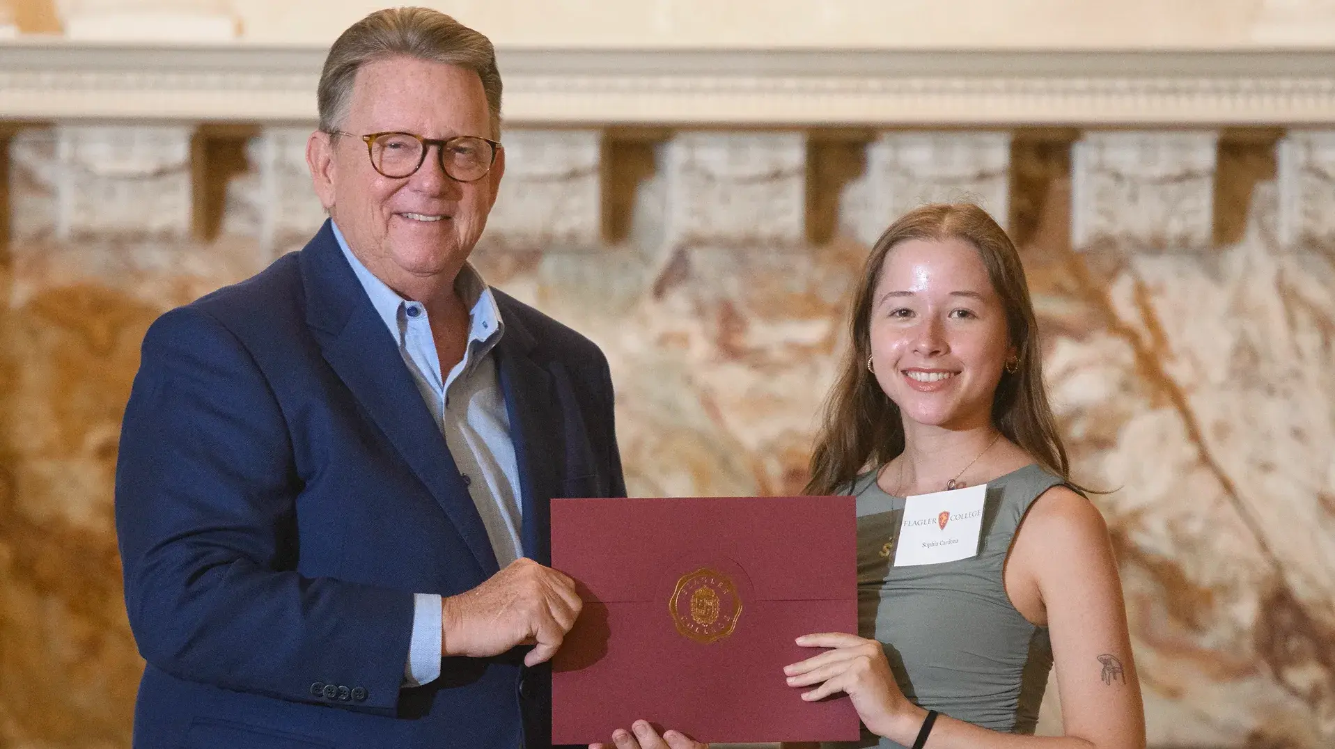 Student receiving degree from President of Flagler