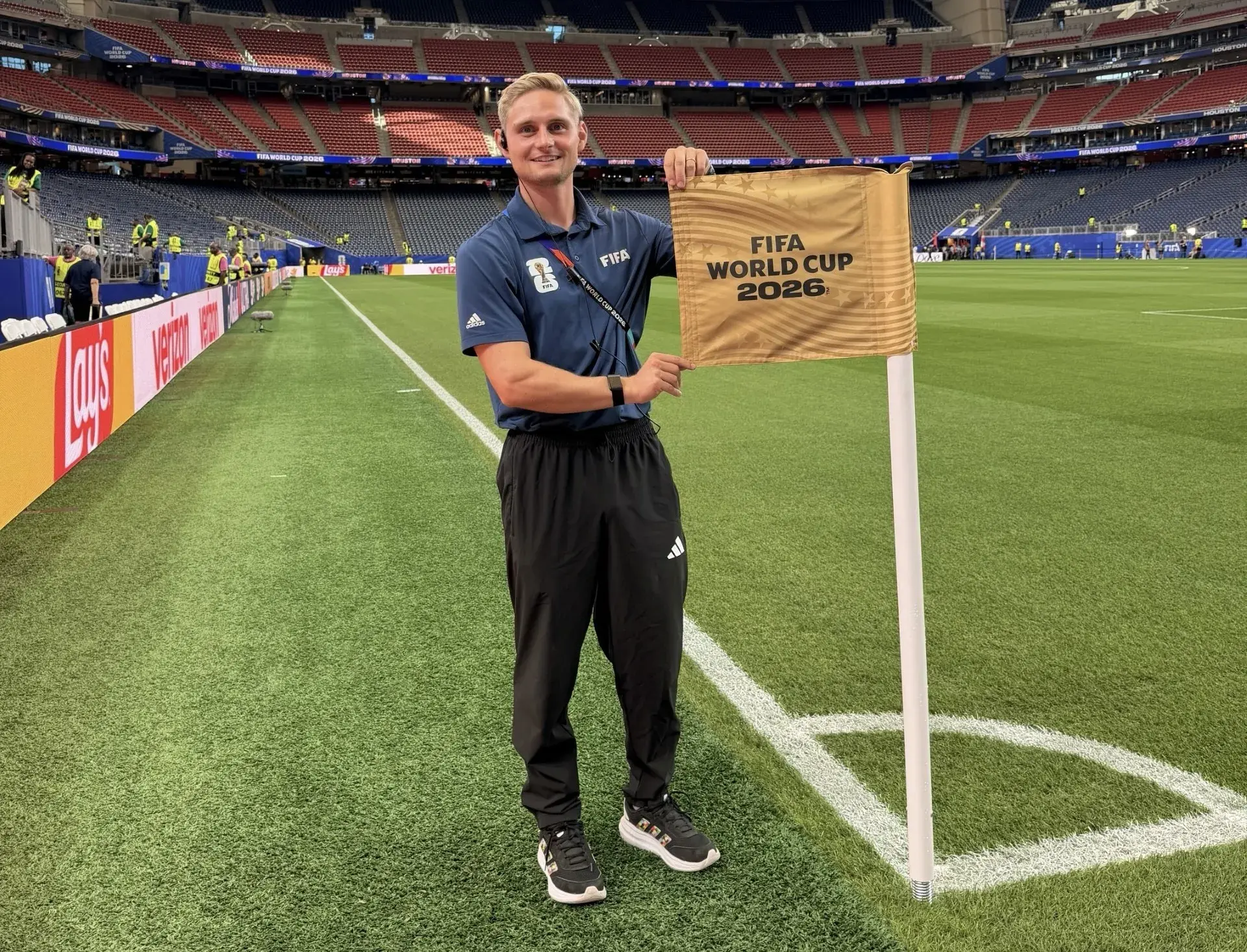 Ben Straw holding up a corner flag at the FIFA World Cup