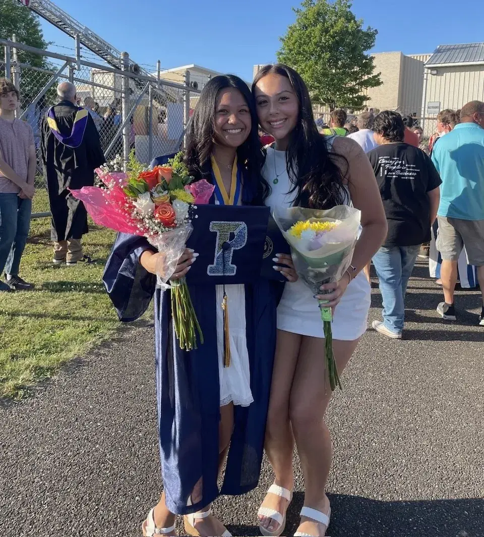 Chloe Fenninmore and her family member after the family member's graduation