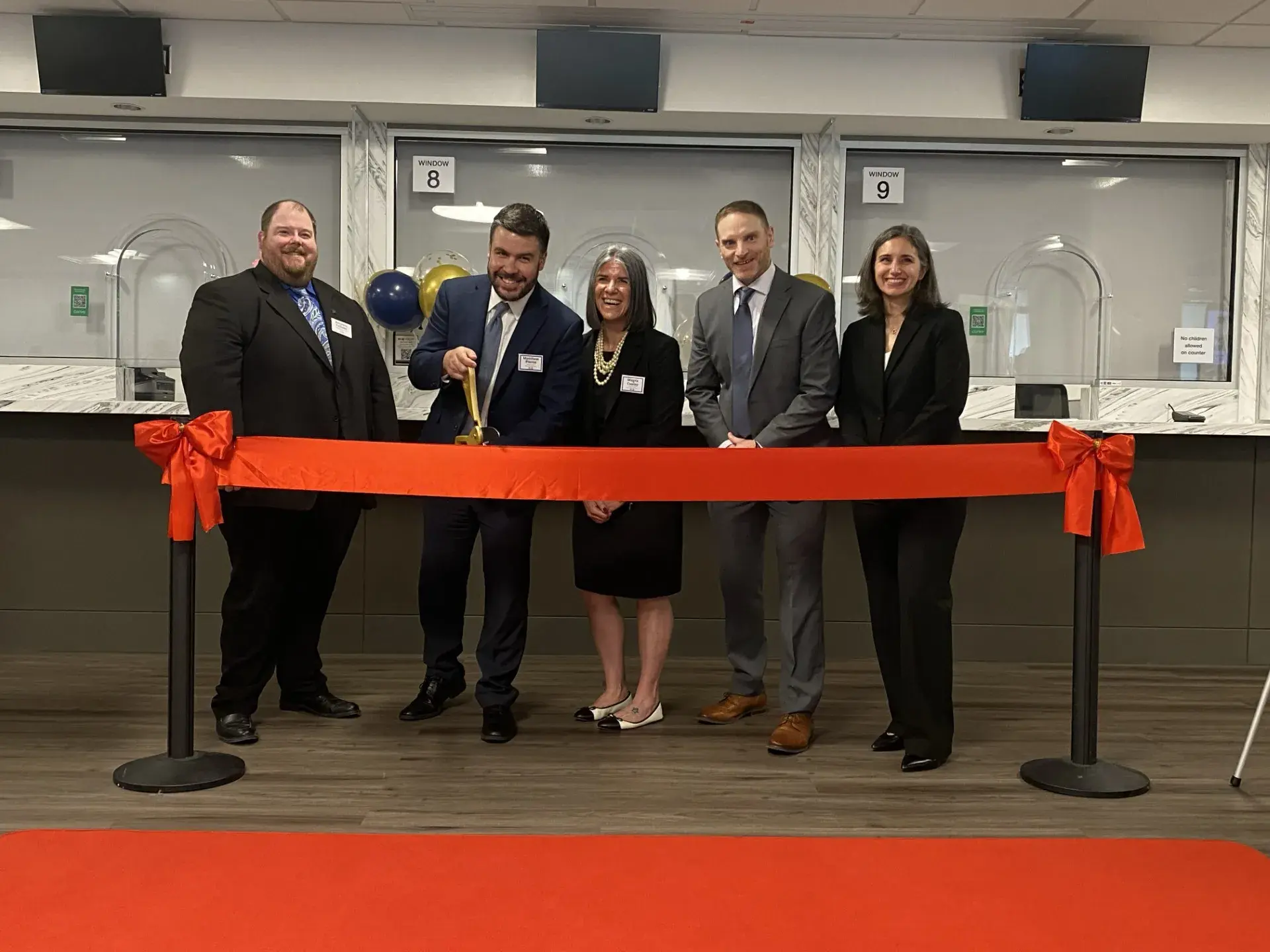 Alum Matt Pierce cuts ribbon at US Passport Office