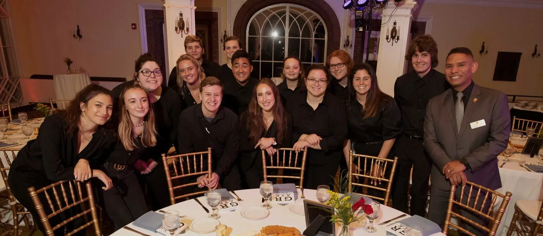 Addison Da Silva during her time at Flagler standing alongside fellow HTM alumni