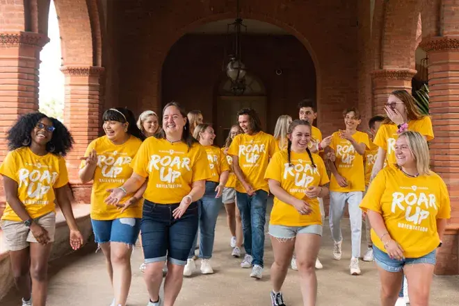 Roar-Up-2023-walking.jpg All of the Orientations Leaders walking towards the camera in the Ponce Courtyard